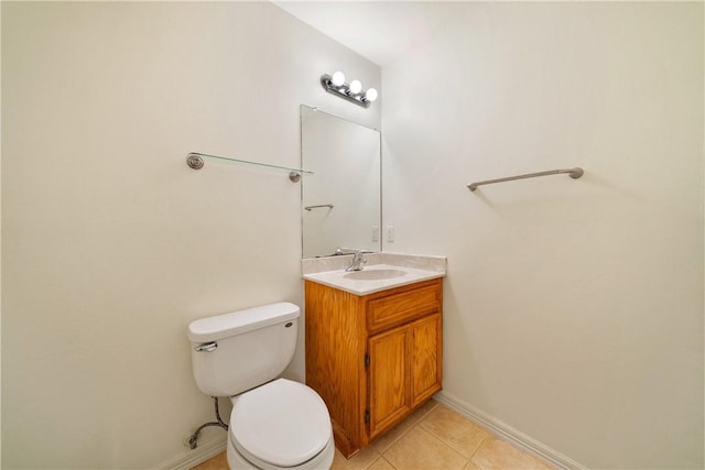 half bathroom featuring toilet, vanity, tile patterned floors, and baseboards