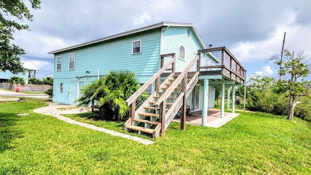 619 Copano Cove Rd, Rockport, TX 78382 - rear view of house featuring a yard, a deck, stairs, and a patio area