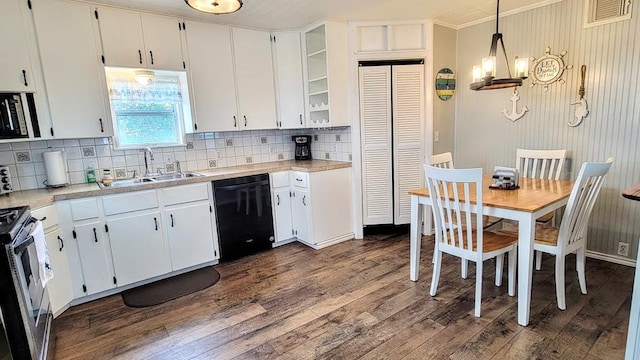 619 Copano Cove Rd, Rockport, TX 78382 - kitchen featuring black dishwasher, stove, dark wood-style flooring, light countertops, and decorative backsplash