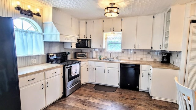 619 Copano Cove Rd, Rockport, TX 78382 - kitchen featuring black appliances, dark wood-style flooring, and white cabinetry