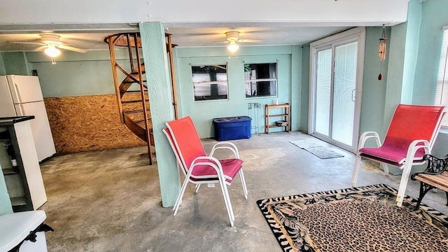 619 Copano Cove Rd, Rockport, TX 78382 - sitting room featuring ceiling fan, unfinished concrete flooring, and stairs