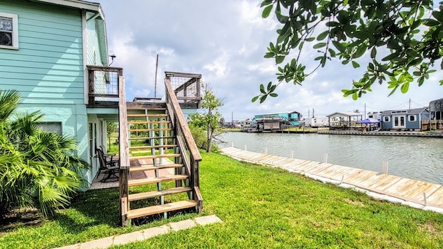 619 Copano Cove Rd, Rockport, TX 78382 - view of green lawn featuring stairs, a water view, and a boat dock