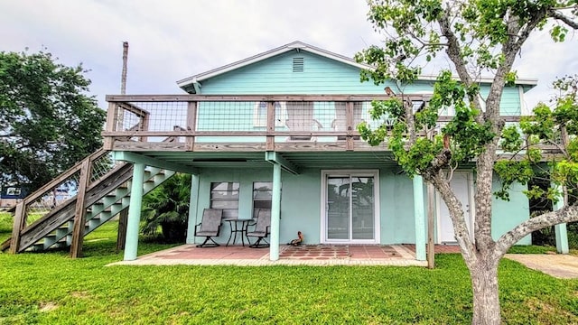 619 Copano Cove Rd, Rockport, TX 78382 - back of property featuring a wooden deck, a yard, and stucco siding