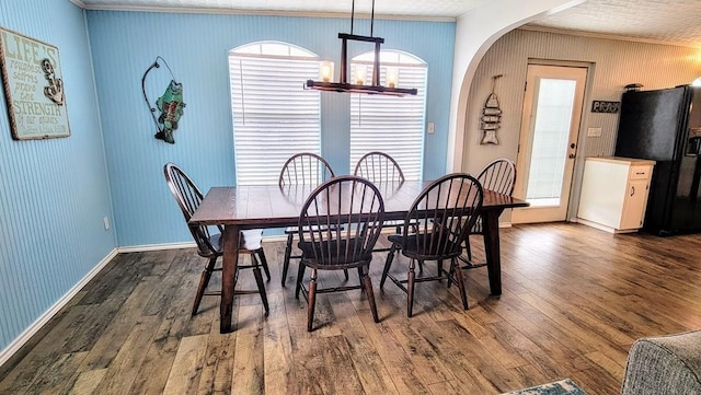 619 Copano Cove Rd, Rockport, TX 78382 - dining room featuring ornamental molding, dark wood finished floors, and healthy amount of natural light