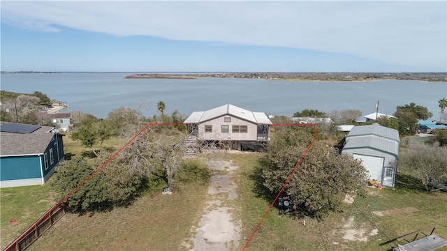 birds eye view of property with a water view