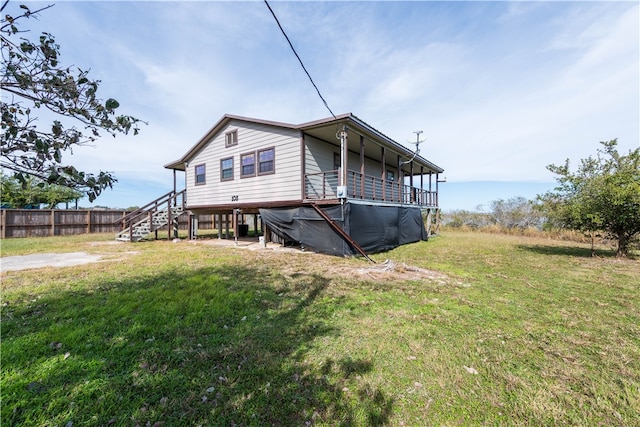 rear view of property with a yard