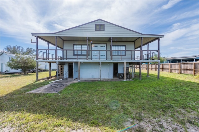 rear view of property with a deck and a lawn