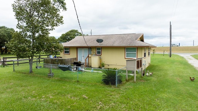 back of house with a yard