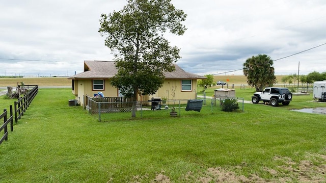 rear view of house featuring a lawn