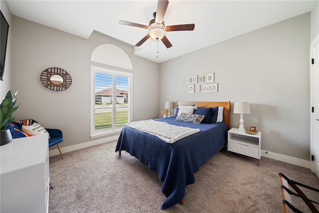 bedroom with light carpet, ceiling fan, baseboards, and lofted ceiling