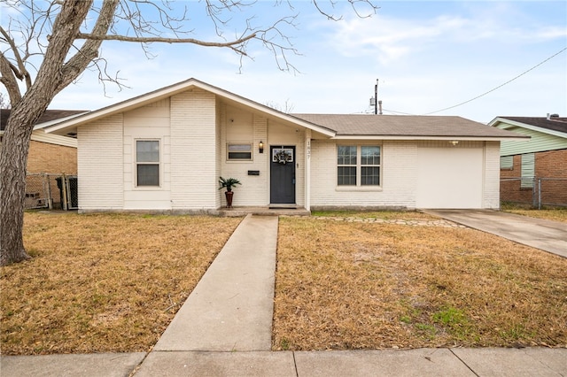 ranch-style home featuring a garage and a front lawn