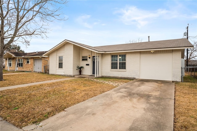 single story home featuring a garage and a front lawn