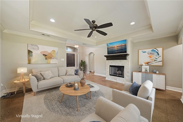 2706 Lake Rhapsody Dr, Corpus Christi, TX 78414 - living room with arched walkways, a tray ceiling, ceiling fan, a fireplace, and crown molding