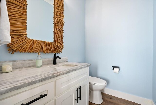 laundry area with washing machine and clothes dryer and wood-type flooring