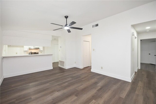 unfurnished living room featuring ceiling fan and dark hardwood / wood-style floors