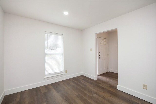 unfurnished room featuring dark hardwood / wood-style flooring