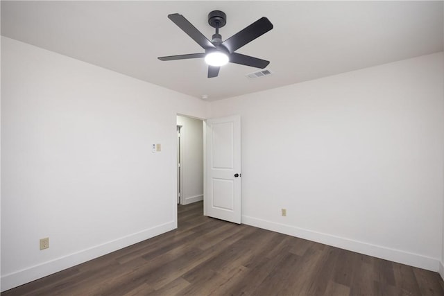 spare room with ceiling fan and dark hardwood / wood-style flooring