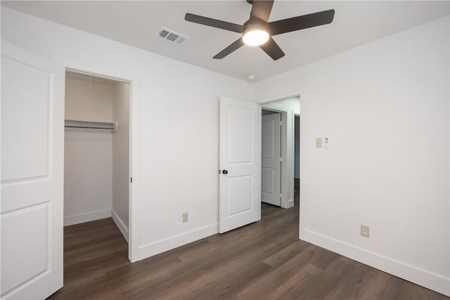 unfurnished bedroom with a closet, ceiling fan, and dark wood-type flooring