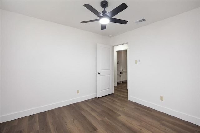 spare room with dark hardwood / wood-style floors and ceiling fan