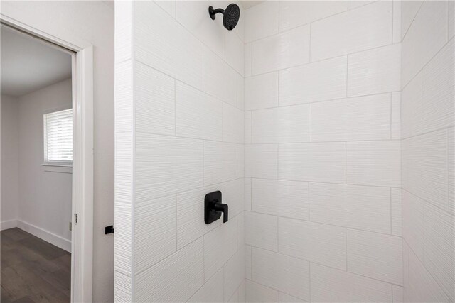 interior details with tiled shower and hardwood / wood-style flooring