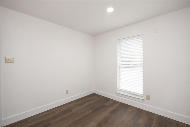 unfurnished room with dark hardwood / wood-style floors