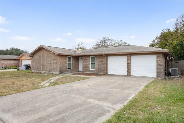 ranch-style home featuring a front yard, central AC, and a garage