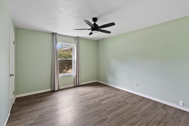 empty room featuring hardwood / wood-style flooring, ceiling fan, and a textured ceiling