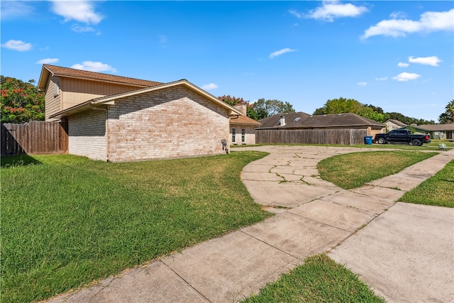 view of side of property featuring a yard