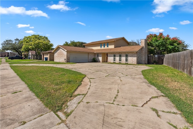 view of front of house featuring a garage and a front yard