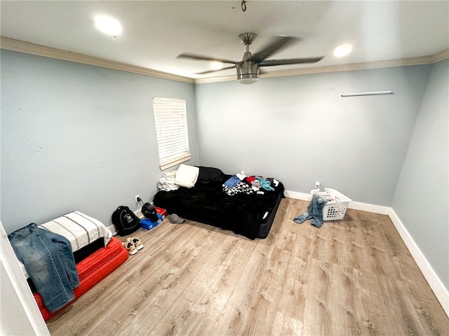 bedroom featuring ceiling fan, crown molding, and wood-type flooring