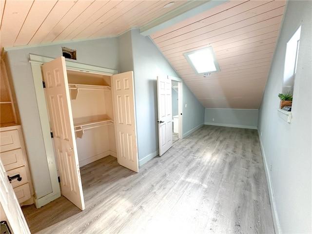 additional living space featuring wooden ceiling, lofted ceiling with beams, and light hardwood / wood-style floors