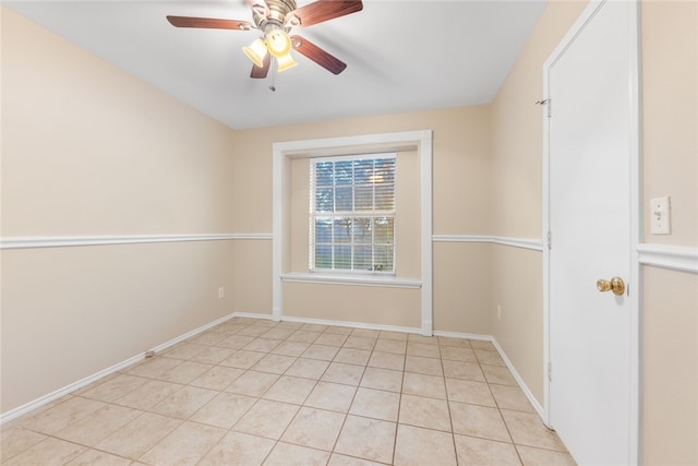 tiled spare room with ceiling fan