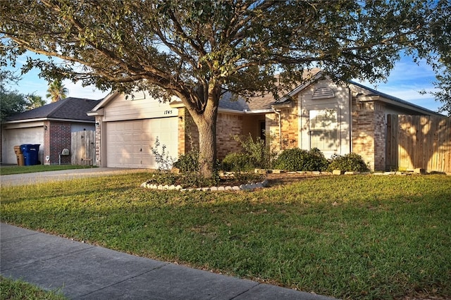 ranch-style home featuring a front lawn and a garage