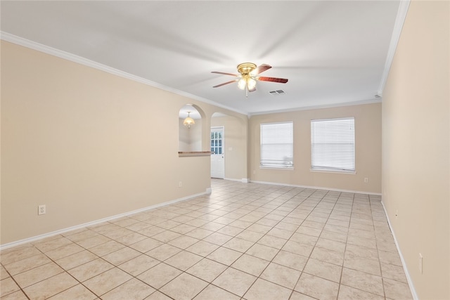 spare room featuring light tile patterned floors, ceiling fan, and ornamental molding