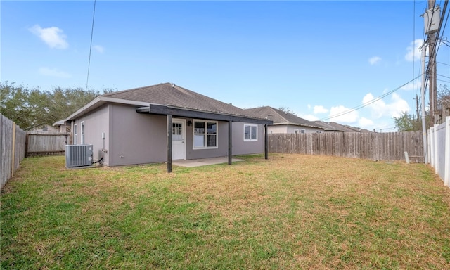 back of property featuring a patio, a fenced backyard, central AC, a lawn, and stucco siding