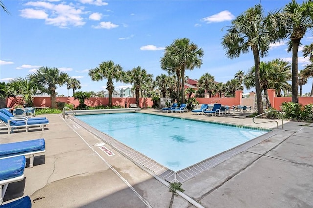 pool featuring a patio area and fence