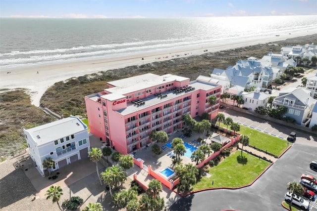 birds eye view of property featuring a view of the beach and a water view