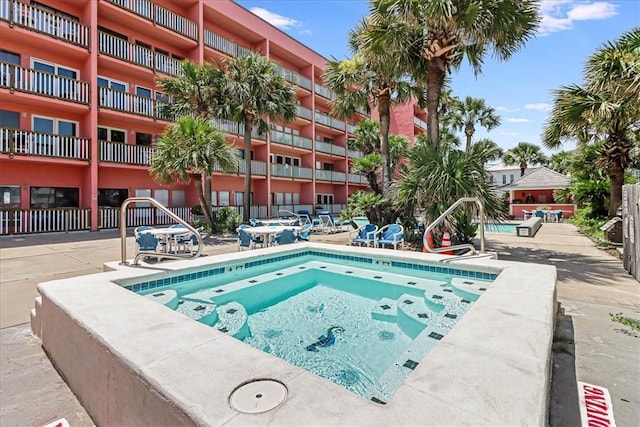 view of pool featuring a hot tub