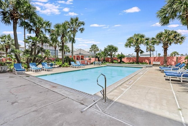 pool featuring fence and a patio