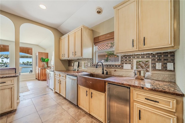 15929 San Felipe Dr, Corpus Christi, TX 78418 - kitchen featuring dishwasher, lofted ceiling, light brown cabinetry, a sink, and plenty of natural light