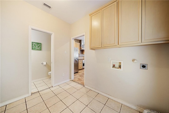 15929 San Felipe Dr, Corpus Christi, TX 78418 - washroom featuring hookup for an electric dryer, cabinet space, washer hookup, light tile patterned floors, and baseboards