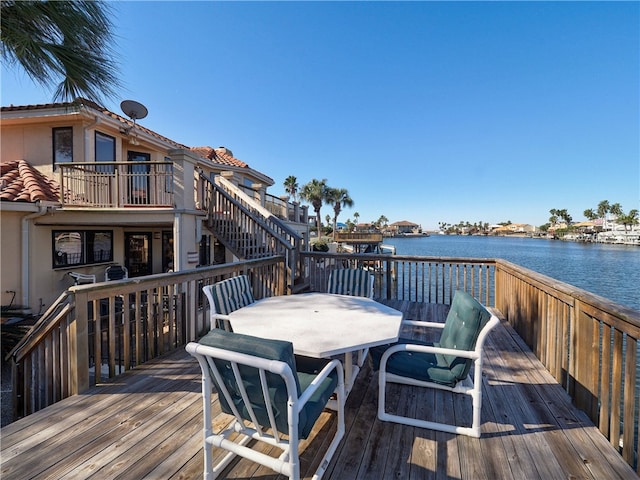 15806 Punta Espada, Corpus Christi, TX 78418 - wooden deck featuring a water view, outdoor dining space, and stairway
