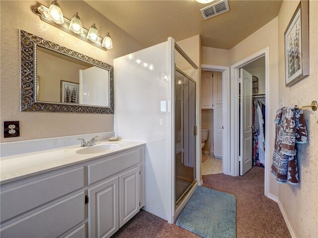 full bathroom with tile patterned flooring, vanity, toilet, a textured ceiling, and shower / bath combo with shower curtain