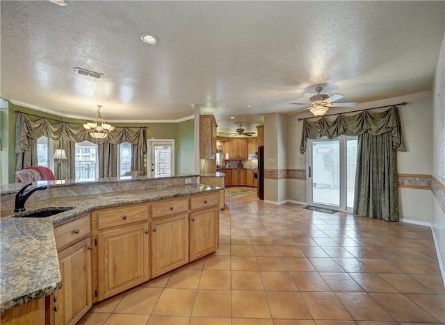15806 Punta Espada, Corpus Christi, TX 78418 - kitchen with a sink, a textured ceiling, a ceiling fan, baseboards, and light stone countertops