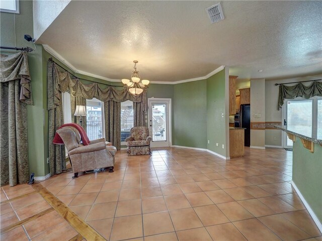 15806 Punta Espada, Corpus Christi, TX 78418 - sitting room featuring a textured ceiling, a chandelier, baseboards, light tile patterned floors, and crown molding
