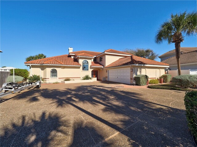 mediterranean / spanish-style house featuring a garage