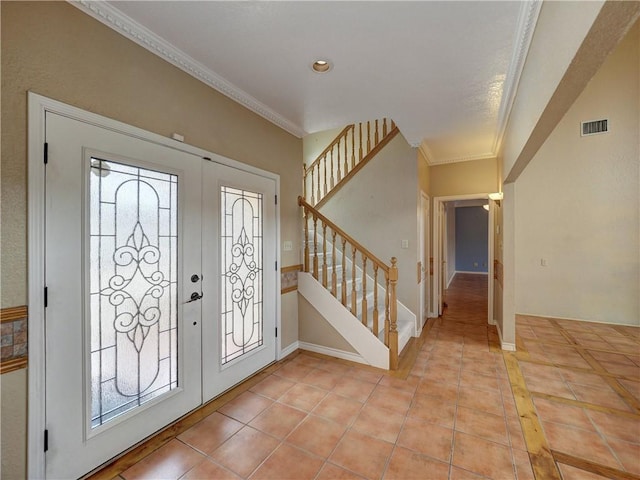 15806 Punta Espada, Corpus Christi, TX 78418 - foyer featuring healthy amount of natural light, light tile patterned floors, stairway, crown molding, and baseboards