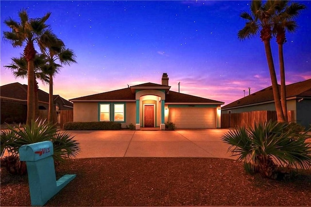 ranch-style home with concrete driveway, fence, a garage, a chimney, and stucco siding