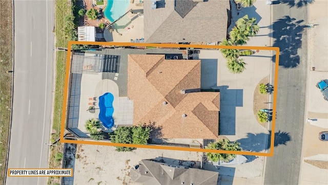 aerial view of property and surrounding area with property parcel outlined and a pool area