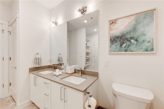 bathroom with toilet and vanity